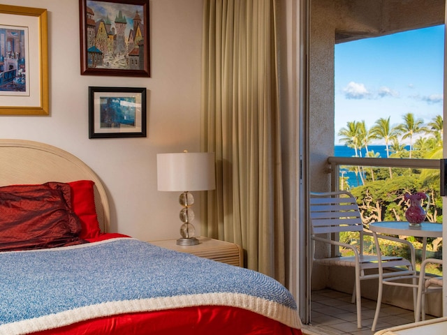 tiled bedroom featuring a water view and multiple windows