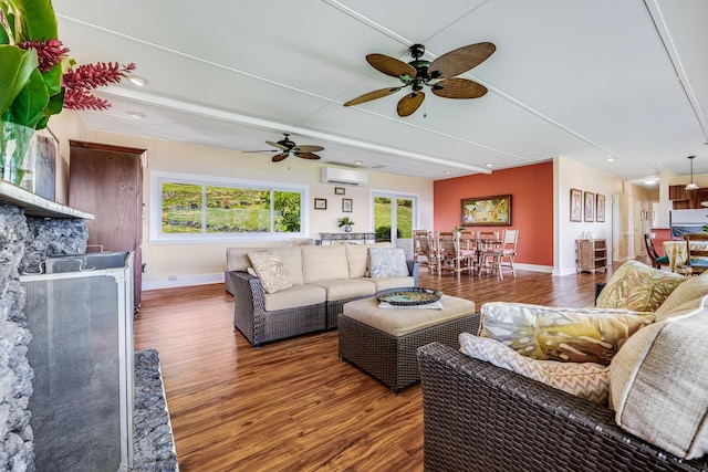 living area with a wall mounted AC, recessed lighting, dark wood finished floors, and baseboards