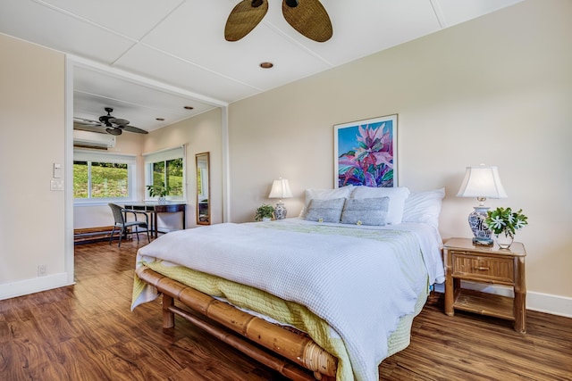 bedroom featuring an AC wall unit, ceiling fan, baseboards, and wood finished floors