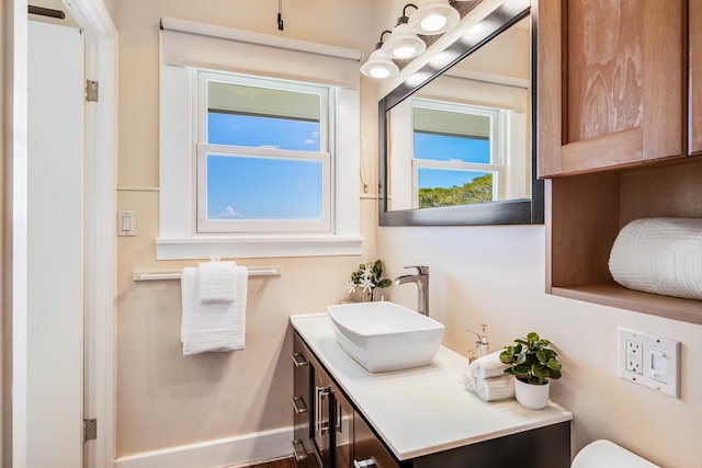 half bath featuring vanity and baseboards