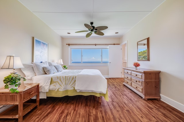 bedroom with baseboards and wood finished floors