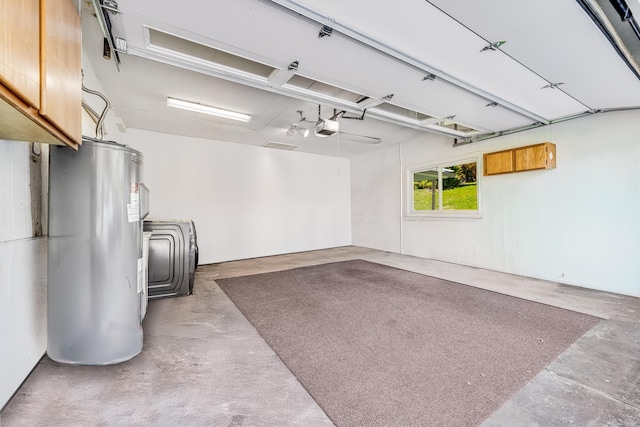 garage featuring electric water heater and a garage door opener