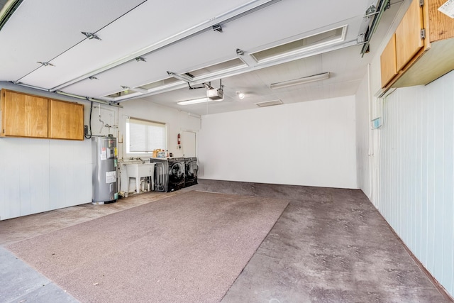 garage with water heater, independent washer and dryer, a sink, and a garage door opener