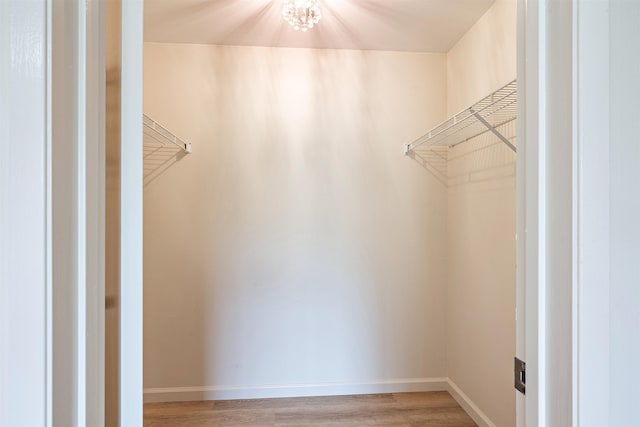 74 Kunihi Ln Unit 430, Kahului, HI 96732 - spacious closet featuring light wood finished floors and a chandelier
