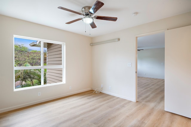 empty room featuring ceiling fan and light hardwood / wood-style flooring