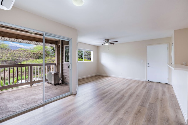 spare room with ceiling fan and light wood-type flooring