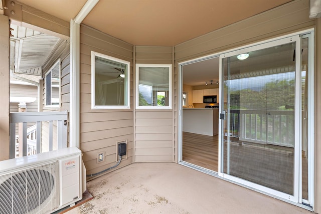 unfurnished sunroom with ac unit