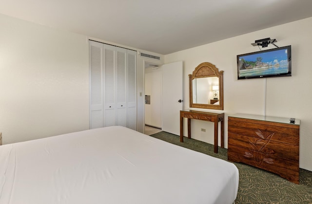 bedroom with visible vents, carpet, and a closet