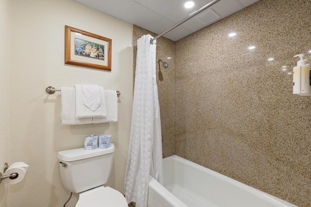 bathroom featuring visible vents, toilet, and shower / bath combination with curtain