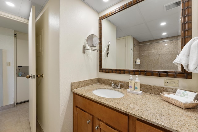 bathroom with tile patterned flooring, visible vents, walk in shower, recessed lighting, and vanity