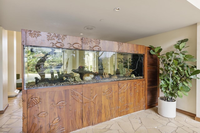 bar with recessed lighting and stone tile flooring