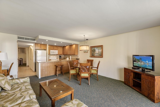 living area featuring recessed lighting, visible vents, and light colored carpet