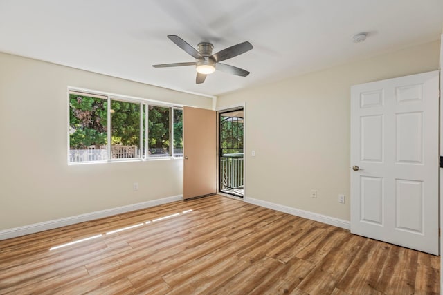 empty room with ceiling fan and light hardwood / wood-style flooring