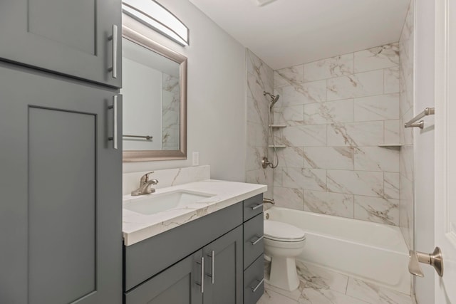 full bathroom featuring vanity, toilet, and tiled shower / bath