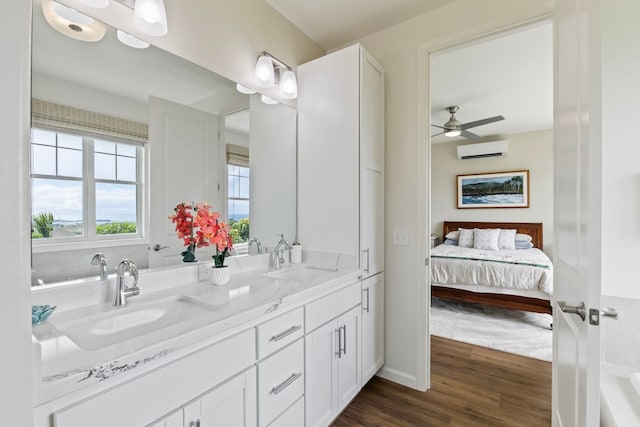 115 Nanu Pl, Wailuku, HI 96793 - ensuite bathroom with a wall mounted AC, double vanity, wood finished floors, a ceiling fan, and a bathtub