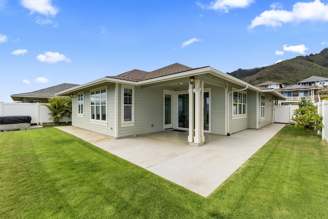 115 Nanu Pl, Wailuku, HI 96793 - back of property with a fenced backyard, a mountain view, a patio, and roof with shingles
