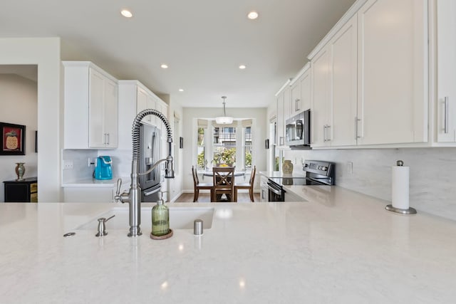 115 Nanu Pl, Wailuku, HI 96793 - kitchen with stainless steel appliances, white cabinetry, recessed lighting, backsplash, and light stone countertops