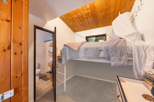 bedroom with wood ceiling, vaulted ceiling, and carpet flooring