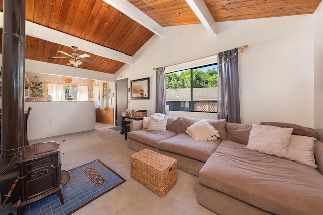 living room with lofted ceiling with beams, a wood stove, wooden ceiling, and carpet flooring