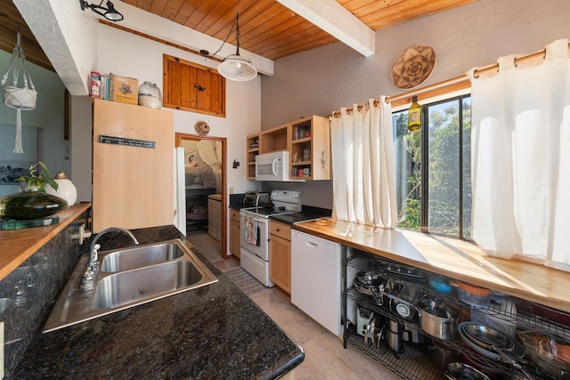 kitchen featuring decorative light fixtures, beamed ceiling, sink, wood ceiling, and white appliances