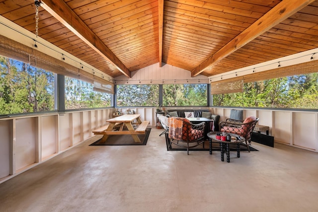 sunroom featuring vaulted ceiling with beams