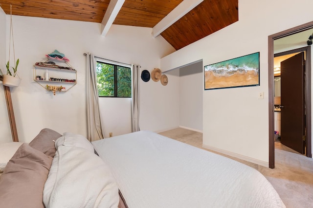 bedroom with vaulted ceiling with beams, light carpet, and wooden ceiling