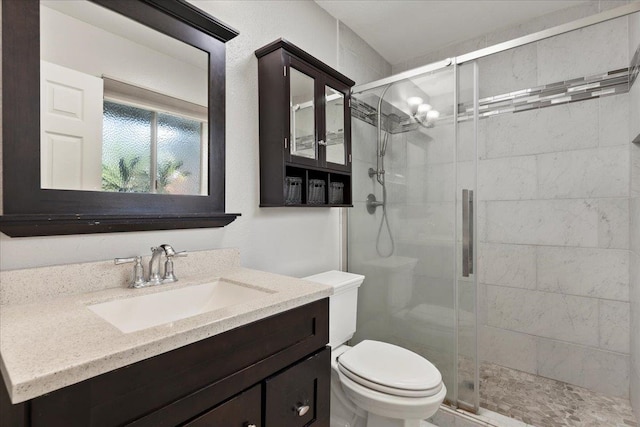 bathroom featuring oversized vanity, toilet, and walk in shower