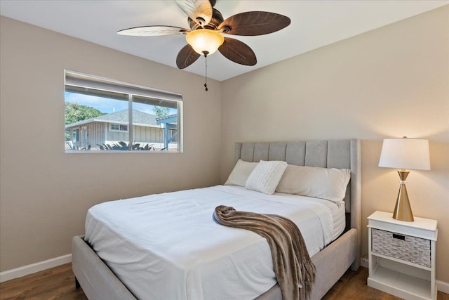 bedroom featuring ceiling fan and dark hardwood / wood-style floors