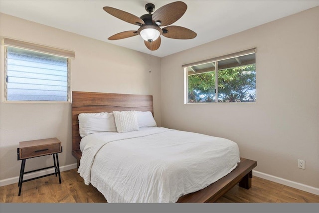 bedroom with ceiling fan and dark hardwood / wood-style flooring