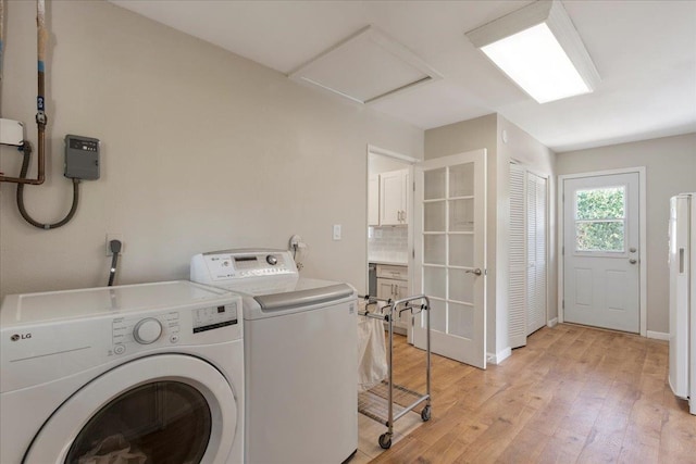 washroom featuring washer and dryer, light wood-type flooring, and electric dryer hookup