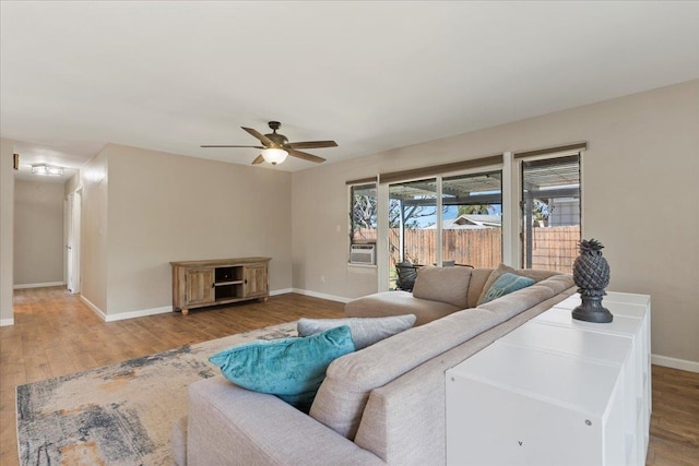 living room featuring hardwood / wood-style floors and ceiling fan