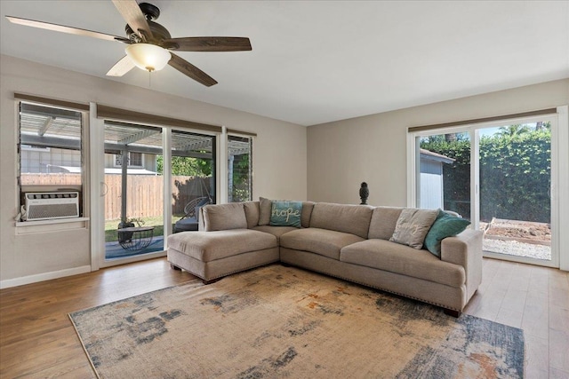 living room featuring ceiling fan and hardwood / wood-style flooring