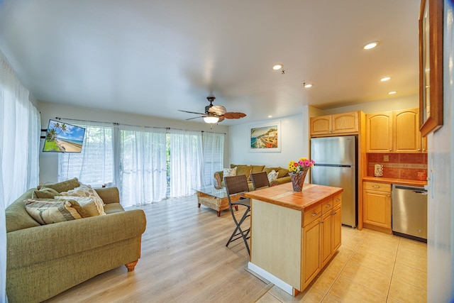 3559 Lower Honoapiilani Rd Unit 720, Lahaina, HI 96761 - kitchen with stainless steel appliances, open floor plan, tile countertops, light brown cabinetry, and recessed lighting