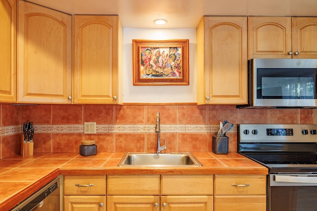 3559 Lower Honoapiilani Rd Unit 720, Lahaina, HI 96761 - kitchen featuring appliances with stainless steel finishes, a sink, tile counters, and light brown cabinetry
