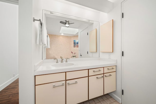 bathroom featuring vanity, ceiling fan, and wood-type flooring