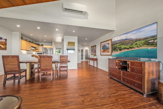 dining room featuring an AC wall unit and dark hardwood / wood-style flooring