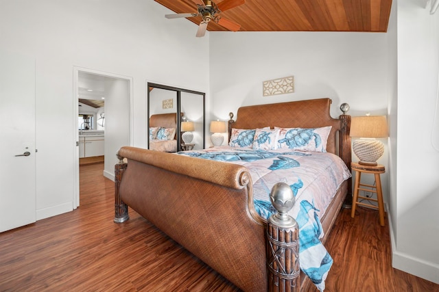 bedroom featuring wood ceiling, a closet, hardwood / wood-style floors, high vaulted ceiling, and ceiling fan