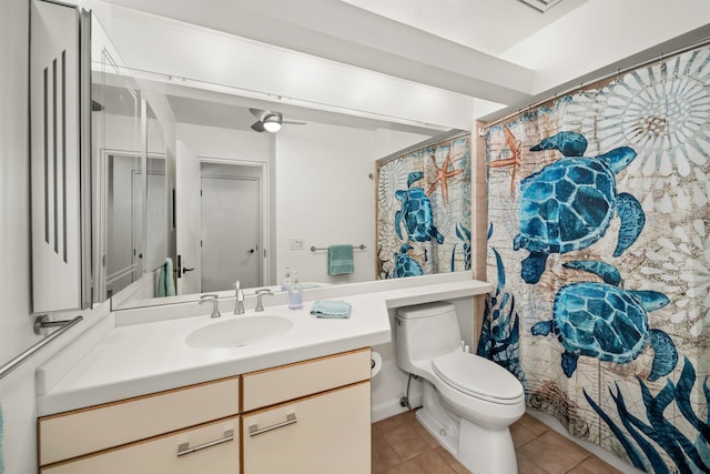 bathroom with toilet, vanity, tile patterned floors, and a shower with shower curtain