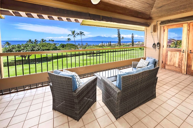 view of patio / terrace featuring a water and mountain view and an outdoor hangout area