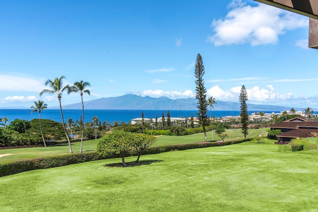 view of community featuring a yard and a water and mountain view