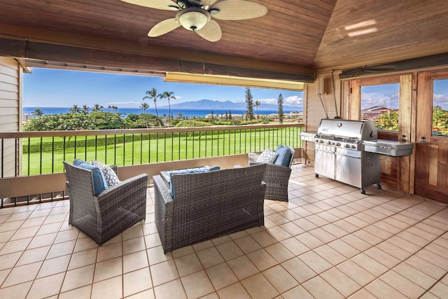 view of patio with a grill, an outdoor kitchen, a mountain view, an outdoor living space, and ceiling fan