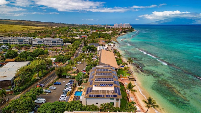 aerial view with a water view and a beach view