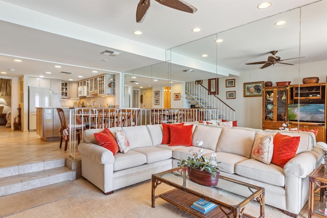 tiled living room with ceiling fan