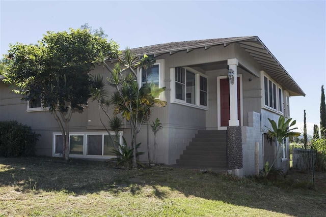 view of side of home with a lawn