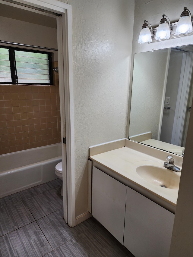 full bathroom with vanity, toilet, and tiled shower / bath