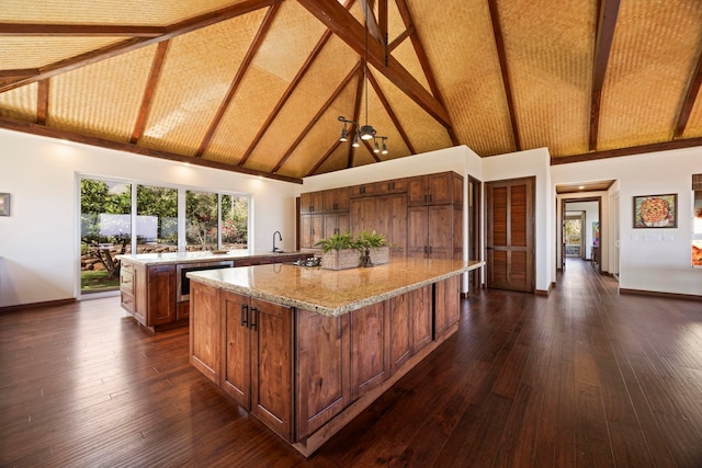 kitchen with beamed ceiling, a center island, high vaulted ceiling, and dark hardwood / wood-style floors