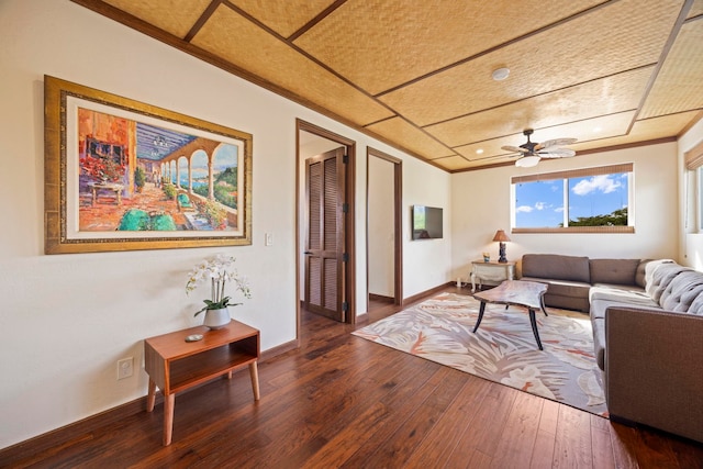 living room with ceiling fan, crown molding, and dark hardwood / wood-style floors