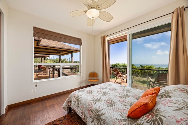 bedroom with multiple windows, ceiling fan, hardwood / wood-style floors, and access to exterior