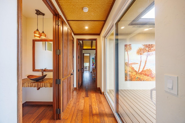 hall featuring hardwood / wood-style floors and sink