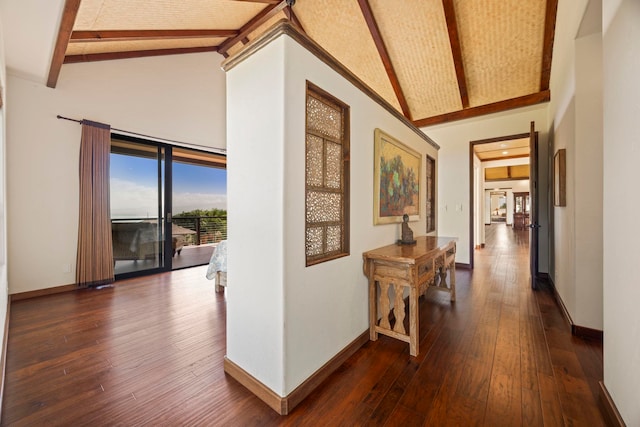 corridor featuring beam ceiling, dark hardwood / wood-style flooring, and high vaulted ceiling